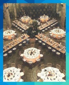 an overhead view of tables and chairs with wine barrels in the background