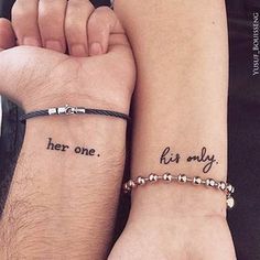 two people holding hands with tattoos on their arms and the words her one, her only