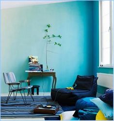 a living room with blue walls and furniture