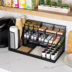 a kitchen counter with coffee cups and other items on it