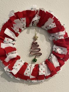 a red and white christmas wreath hanging on the wall