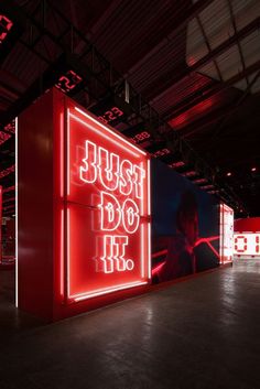 a red neon sign that says just do it in white letters on the front and back