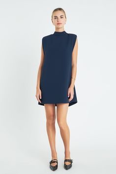 This chic Mock Neck Sleeveless Shift Dress is tailored with shoulder pads and lined for a truly timeless look. It features a mock neckline sleeveless style and flattering fit. Perfect for any occasion this dress is a must-have for any wardrobe and the perfect way to make a statement. Its effortless design and stylish details make it an ideal piece for any occasion from office to date night. Don't miss out on this unique and stylish piece! Mock neck Sleeveless Shoulder padded Lined Hand wash cold