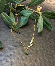 "Olive Necklaces on  branch  with olive leaves .sterling silver . or Gold  vermeil or rose gold vermeil  , Minimal dainty Necklaces, Gift for graduation, Mother's day gift, Gift for sister ♥ Shown at size 17 \" ♥ You can choose the size 14 \"-20\" ♥ High Quality Designer Jewelry ♥ Comes in a cute little package ready for gifting. ♥ Comes with a card. As in photo or you can Send your text .And we will prepare the card ♥ We can stamp the leaf with the letter you choose. Make the jewelry personal CURRENT PRODUCTION TIMES All items are made to order. Usually between 1-3 business days. If you need it sooner, please send us a message on Etsy :) PEXPEDITED SHIPPING You can choose a faster shipping option by buying the Expedited shipping listing here: https://www.etsy.com/listing/265766138/expedit Olive Leaf Necklace, Olive Necklace, Olive Jewelry, Necklaces Gift, Gift For Graduation, Olive Leaves, Dainty Necklaces, Delicate Necklaces, Gift For Sister