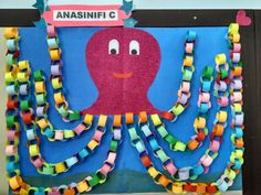 a bulletin board with an octopus made out of colored paper and streamers attached to it