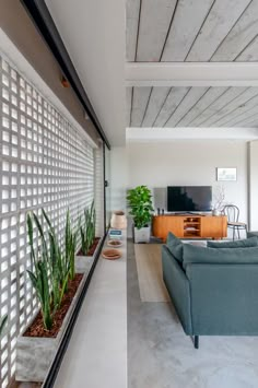 a living room filled with furniture and a flat screen tv mounted to the side of a wall