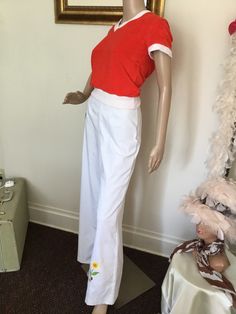 "70's Vintage White High Waist Bell Bottom Pants 70's Vintage White High Waist Bell Bottom Pants White pants with red embroidered lady bug, yellow pink embroidered flowers at bottom of pant legs, Hi rise waist with front/back darts, wide leg bell bottoms, and back button/zip closure. Listing for pants only. Good vintage condition. Has small stains at bottom of pant leg, and two at waist, (see pics). Tag Size: 11 Measurements: Waist: 26\" Rise: 13\" Hips: 36\" Inseam: 31 1/2\" Length: 43 1/2\" Leg Width: 12 1/2 seam to seam" Vintage Fitted Bottoms With Elastic Waistband, Retro Fitted Bottoms With Elastic Waistband, Vintage Full Length Bottoms For Spring, Retro Fitted Wide Leg Pants For Spring, Fitted Retro Wide Leg Pants For Spring, Retro Wide Leg Full Length Pants For Spring, Retro Cotton Bottoms For Spring, Retro Wide Leg Pants For Spring, Spring Vintage Full Length Pants