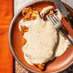 a plate that has some kind of food on it with a knife and fork in it