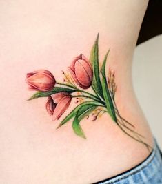 a close up of a woman's stomach with tulips on the side