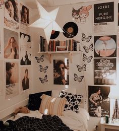 a bed room with a neatly made bed and lots of pictures on the wall