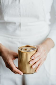 a woman holding a cup of coffee in her hands by lumina for stocks on stocks