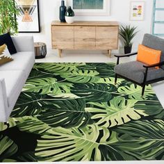 a living room with a couch, chair and large rug on the floor in front of it