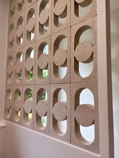 a wall made out of cement blocks with circles and shapes on it's sides