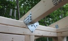 a wooden structure with metal brackets attached to it