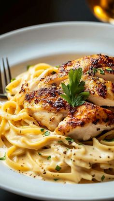 a white plate topped with chicken and pasta