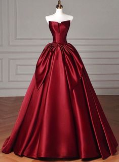 A garment of regal allure, this prom dress is the epitome of classic elegance with a modern twist. Crafted in a stunning shade of deep red, the dress boasts a satin finish that gleams with sophistication. The strapless design highlights the shoulders and adds a sense of bold femininity to the wearer. A beautifully executed bow sits prominently at the waist, drawing the eye to the slimmest part of the figure and giving way to a voluminous skirt that cascades to the floor. Whether you're stepping onto the dance floor or posing for pictures, this dress is guaranteed to make a grand statement, leaving a trail of awe in your wake. Burgundy Pageant Dress, Ball Gown Dresses Elegant Red, Red Masquerade Dress, Deep Red Prom Dress, Full Sleeve Prom Dress, Bow Prom Dress, Waist Drawing, Wine Red Prom Dress, Red Ball Gowns