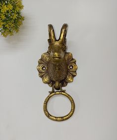 a golden metal object with a rabbit head on it