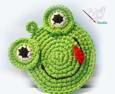 a crocheted green frog purse with eyes