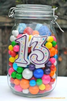 a glass jar filled with lots of colorful candies