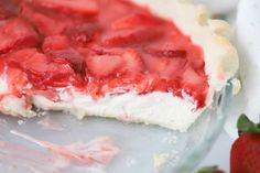 a close up of a pie with strawberries on it