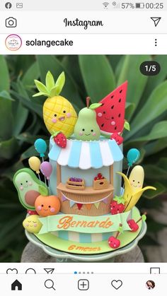 the cake is decorated with fruits and vegetables on it's display stand for sale