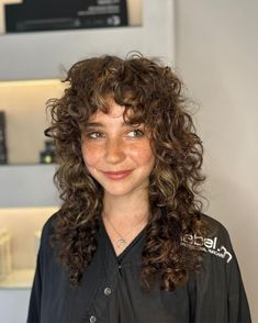 50 Best Wolf Cuts For Curly Hair In 2024 Soft Shag Curly Hair, 70s Shag Curly Hair, Curly Hair Rocker Style, Curly Wolfcut With Bangs, Wolf Cut Hair Bangs, Curly Shag Long, Long Curly Shag With Bangs