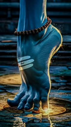 a person's foot in the water with their hands and feet touching each other