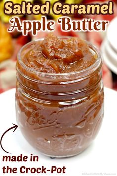 a jar filled with caramel sauce sitting on top of a white plate