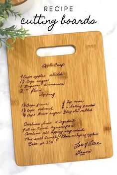 a cutting board with writing on it and a plant next to it that says recipe cutting boards