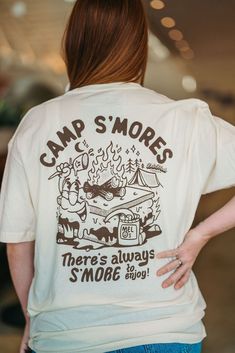 Camp S'mores T-shirt There's always S'more to enjoy! The T-shirt you need if love s'mores! I had the great opportunity to work with the talented Don Leon on this new Deli Fresh Threads T-shirt. T-Shirt Color: Natural Ink Color: Brown 100% Cotton Next Level Screen printed inside tag Screen printed front pocket & back design Stitched hem tag Shirts are unisex so will fit both men and women. Mock up is wearing a Medium Summer Camp Merch, Camping Tshirt Ideas, Camp Merch, Summer Camp Shirts, Camp Tshirt Designs, Camping Shirt Design, Camping Theme Birthday Party, Camp Shirt Designs, Camping Theme Birthday