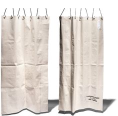 two white paper bags with handles hanging from the top and bottom, one is empty