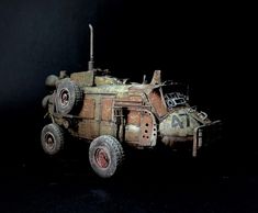 an old, rusted out vehicle with wheels on it's tires is shown against a black background