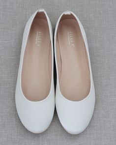 Contemporary and refined designed ballet inspired wedding flats. This smooth satin round toe flat brings comfortable simplicity and elegance to your wedding ceremony and/or reception, bridal party, date night, or everyday fancy wear. Available in 9 colorsDETAILS:COLORS AVAILABLE: Black, Burgundy, Champagne, Dusty Pink, Hunter Green, Ivory, Light Blue, Navy, and WhiteUPPER: Synthetic upper and liningMATERIALS: Manmade outsole STYLE: CASSIE Shoes For Prom Flat, Flat White Shoes, Comfortable Wedding Flats, Elegant Flat Shoes, Prom Flats, Ivory Ballet Flats, Elegant Shoes Flat, Homecoming Shoes, White Flat Shoes