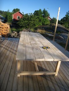 a wooden table sitting on top of a wooden deck