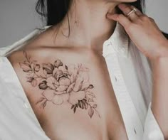 a woman with a flower tattoo on her chest