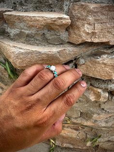 This stunning Moissanite Infinite Love Ring, designed by Navajo Artist Evangeline Perry, features a vibrant turquoise stone, symbolizing infinite love and protection. Each piece is expertly crafted and unique, making it a special addition to any jewelry collection. Experience the beauty and power of Native American artistry with this one-of-a-kind ring.