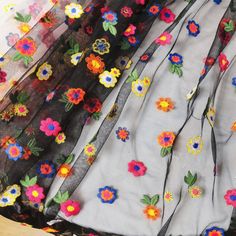 the sheer fabric has colorful flowers on it