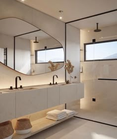 a modern bathroom with two sinks and mirrors