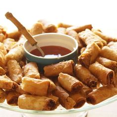 a plate full of fried food with dipping sauce