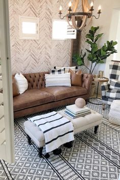 a living room filled with furniture and a chandelier hanging from it's ceiling