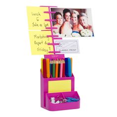 a pink desk organizer with post it notes and pencils in it's holder