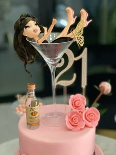 a pink cake with a barbie doll on top and a bottle of booze next to it