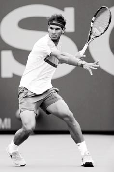 a man holding a tennis racquet on top of a tennis court