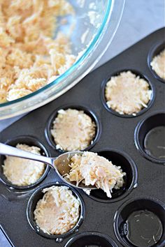 a muffin tin filled with cupcake batter next to a bowl of crumbs