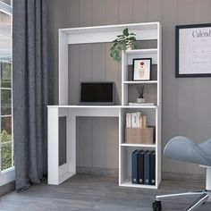 a white computer desk sitting in front of a window next to a chair and book shelf