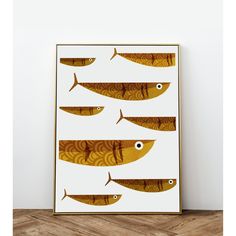 an art print with five fish in different sizes and colors, on a wooden floor