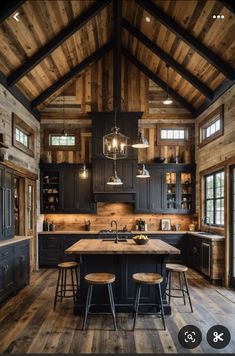 a large kitchen with wooden floors and black cabinetry is featured in this instagram