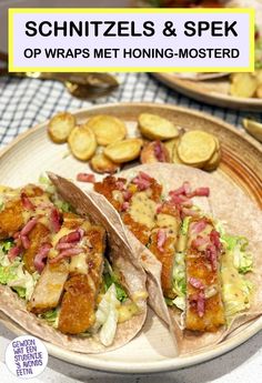 two tacos are sitting on a plate with potato wedges and pickles in the background