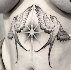 a woman's stomach with two birds on it and a star in the middle