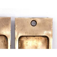 two brass door handles with holes in the middle